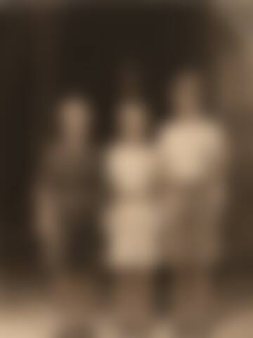 A blurred old photograph of three children